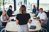A woman leads a team meeting